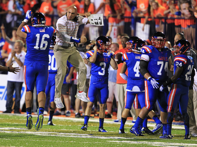 Bishop Gorman defensive coordinator Kenny Sanchez celebrates an interception with defensive ...