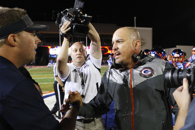 Bishop Gorman coach Tony Sanchez (right) greets St. John Bosco coach Jason Negro after their ...