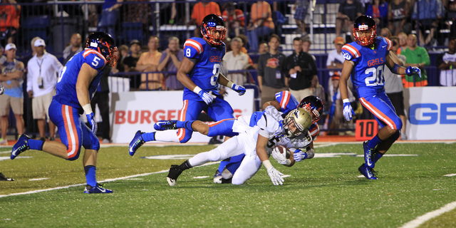 Bishop Gorman safety Damuzhea Bolden brings down St. John Bosco running back Sean McGrew dur ...