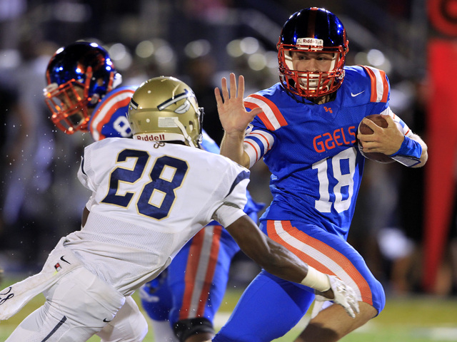 Bishop Gorman quarterback Tate Martell scrambles away from St. John Bosco defensive back Tra ...