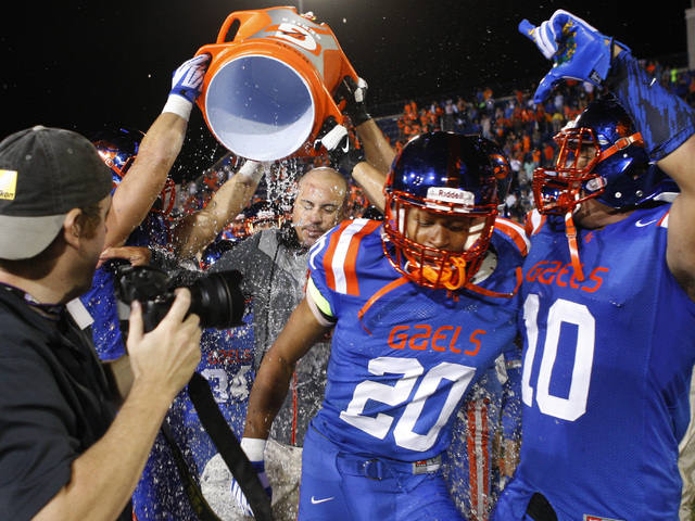 Bishop Gorman head coach Tony Sanchez gets an ice water bath after defeating St. John Bosco ...