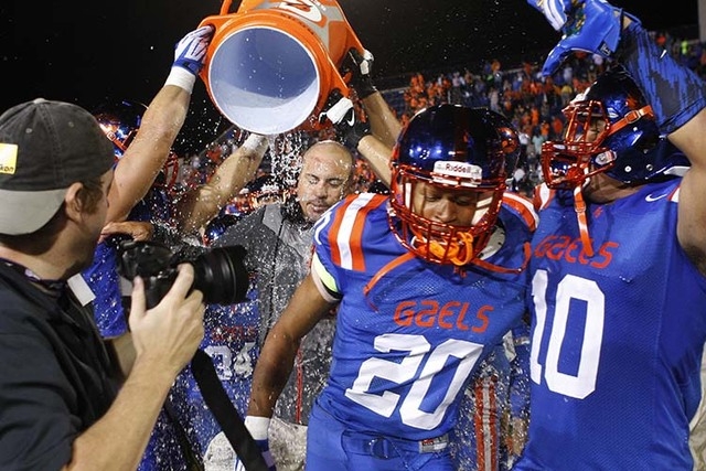 Bishop Gorman junior tight end Alize Jones (8), seen congratulaing teammate Russell Booze af ...