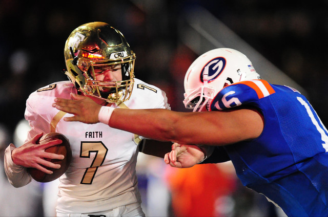 Bishop Gorman defensive end Haskell Garrett , right, sacks Faith Lutheran quarterback Sagan ...