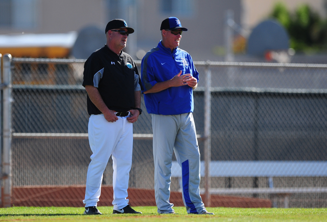 Silverado head coach Brian Whitaker, left, talks with Basic head coach Scott Baker in the fo ...