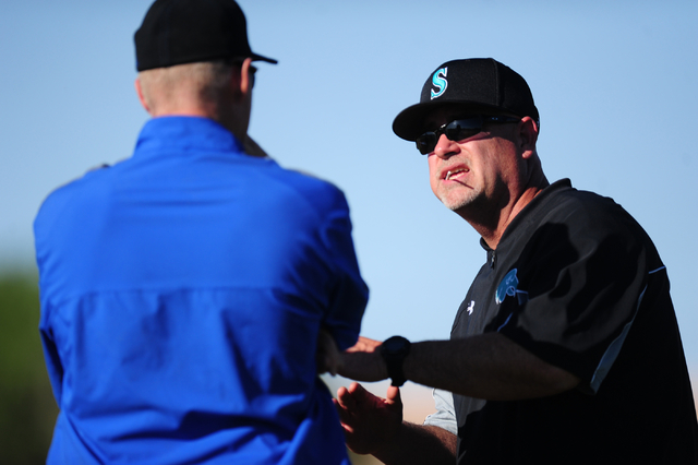 Silverado head coach Brian Whitaker, right, talks with Basic head coach Scott Baker in the f ...