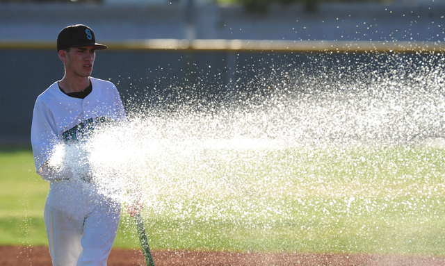 Silverado’s Brandon Sotelo waters the infield after their prep baseball game against B ...