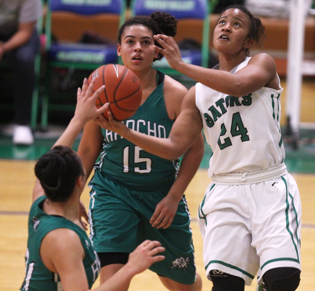 Green Valley’s Yamilei Rodriguez puts up a shot while being defended by Rancho guard T ...