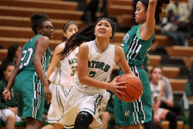 Green Valley guard Gwen Garcia slips past Rancho guard Maureen Macato during their game Tues ...