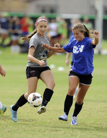 Green Valley girls soccer player Alexis Kirson, left, passes the ball in front of Madison Ho ...