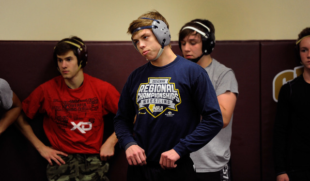 Faith Lutheran wrestler Owen Lawrie, center, looks on during practice. The senior is looking ...