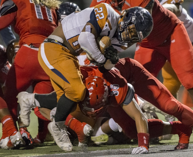 Legacy’s Sam Turner (22) leaps over Arbor View’s J.J. Tuinei (35) for a touchdow ...