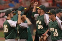 Rancho players high five each other between innings while playing againstBishop Gorman durin ...