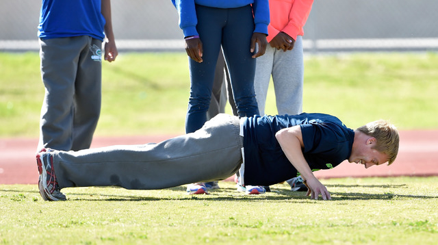 Ian Mack does pushups during practice at Green Valley High School on Tuesday, April 7, 2015. ...