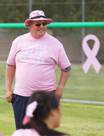 Foothill softball head coach Tom Mayes listens to a fellow coach speak to his team after the ...