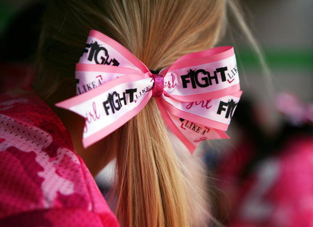 A Foothill softball player wears a pink bow in support of breast cancer awareness during the ...