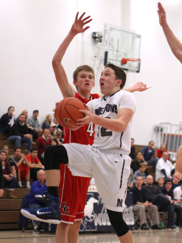 The Meadows guard Ethan Fridman drives past Lincoln County’s Mike Wood during their ga ...