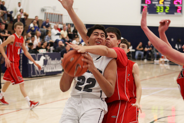 Lincoln County’s Charlie Scott fouls The Meadows center Max Hisatake during Saturday&# ...