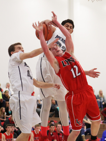 The Meadows center Max Hisatake blocks a shot by Preston Robbins while Meadows forward Renzo ...