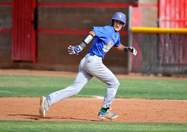 Green Valley’s Keola Paragas runs back to first base, avoiding a pick off, during a re ...