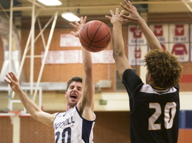 Foothill’s Jeron Bodin (20) gets fouled on the way to the basket by Clark’s Adam ...