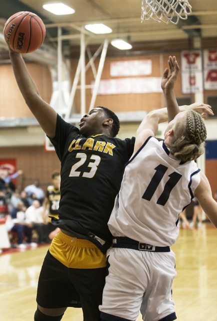 Clark’s Antwon Jackson (23) grabs a rebound over Foothill’s John Platt (11) on ...