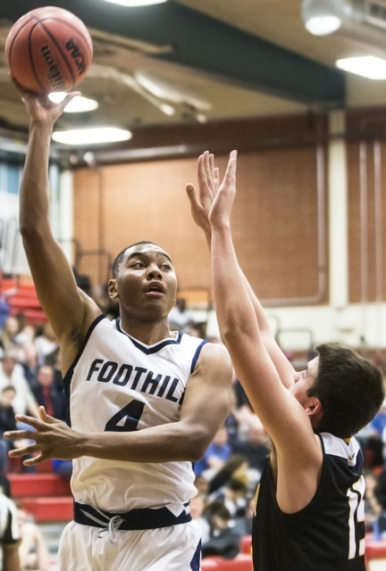 Foothill’s Mauricio Smith (4) shoots a jump hook over Clark’s James Bridges (15) ...