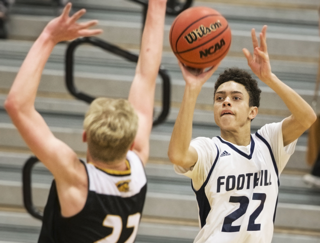 Foothill’s Jace Roquemore (22) shoots a contested three point shot over Clark’s ...