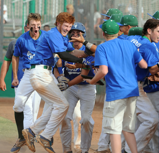 Green Valley’s Keaton Smith, red hair, celebrates with his teammates after he hit a ga ...