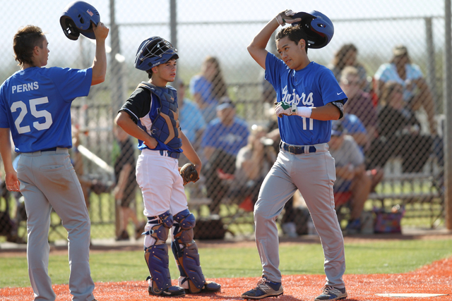 Green Valley’s Blake Inouye (11) raises his helmet in celebration of his home run with ...