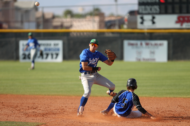 Green Valley’s Jarod Penniman (2) throws to first base for a double play after taking ...