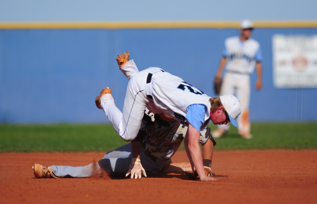 Centennial second baseman Jake Rogers falls over Shadow Ridge baserunner Trevin Reynolds aft ...