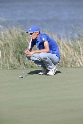 Bishop Gorman’s Owen Rosebeck, observes another golfer while waiting for his turn, dur ...