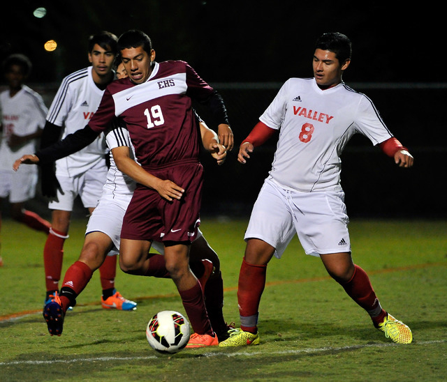 Eldorado’s Alejandro Cisneros (19) is held back from behind as he goes for the ball ag ...