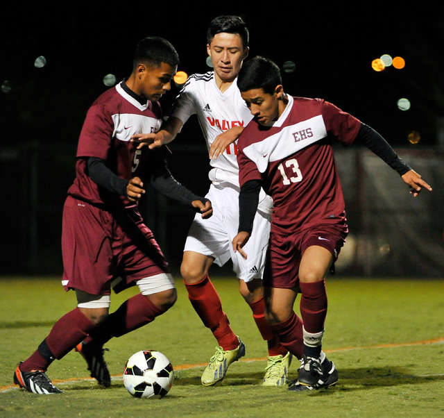 Valley’s Marco Gonzales, center, is surrounded by Eldorado’s Cesar Cruz, left, a ...