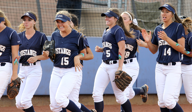 Shadow Ridge players rush toward home place after senior Justin Garganese (not shown) hit a ...