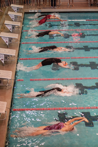 The girls dive in for the start of the 200-yard medley relay race at the Sunset Region meet ...