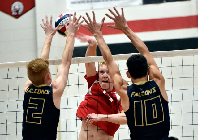 Las Vegas’s Paul Swenson, center, hits the ball against Foothill’s Mason Hansen ...