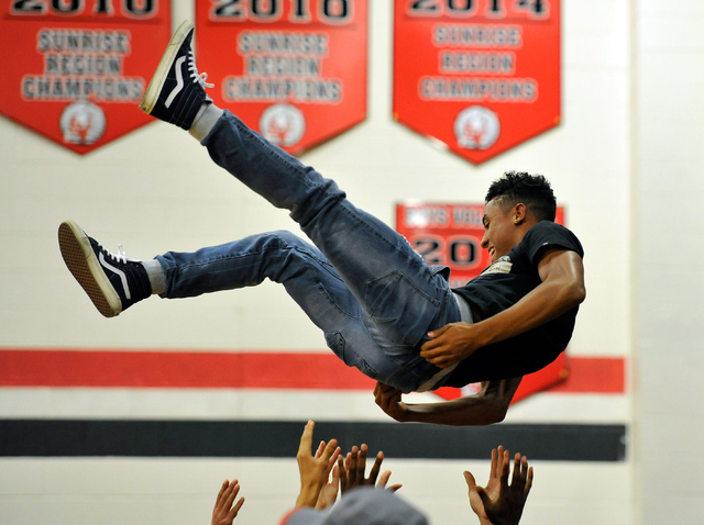 Las Vegas junior Zach Loveland is tossed into the air during the Sunrise Region boys volley ...