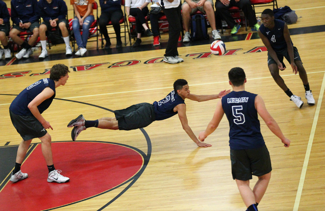 Legacy’s Anthony Madden (7) dives to make a dig as Trent Compton (8), Braden Liu (5) a ...