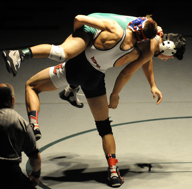 Liberty’s Storm Roper of Liberty, center, slams Green Valley’s Giullian Nakamats ...