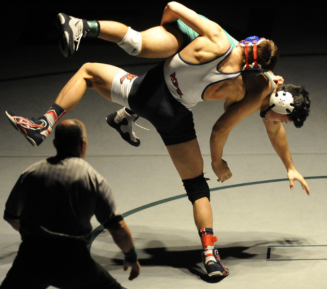 Liberty’s Storm Roper of Liberty, center, slams Green Valley’s Giullian Nakamats ...