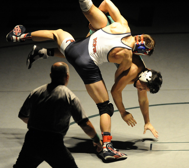 Liberty’s Storm Roper of Liberty, center, slams Green Valley’s Giullian Nakamats ...