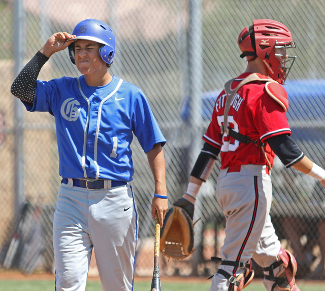 Bishop Gorman’s Antonio Rainone, left, walks away from the batter’s box near Arb ...