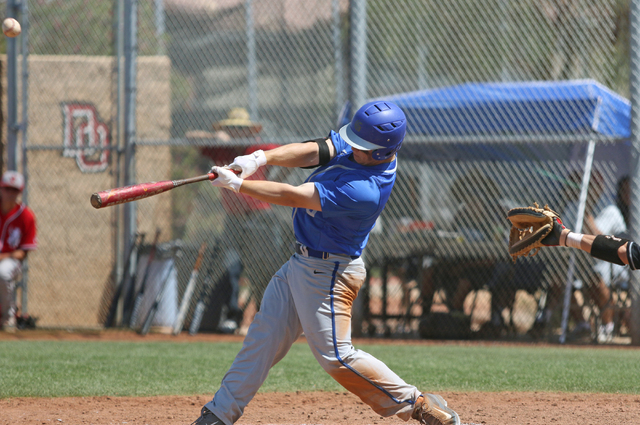 Bishop Gorman’s Matt Hudgins his the ball during the Division I Sunset Region high sch ...