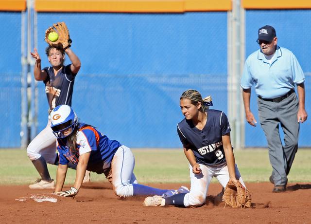 Bishop Gorman’s Shelby Estocado, left, slides into second base past Shadow Ridge&#8217 ...