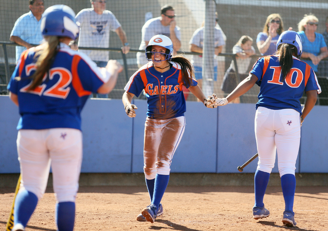 Bishop Gorman’s Shelby Estocado, center, celebrates with teammates Dayton Yingling, le ...