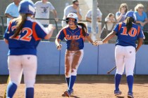 Bishop Gorman’s Shelby Estocado, center, celebrates with teammates Dayton Yingling, le ...