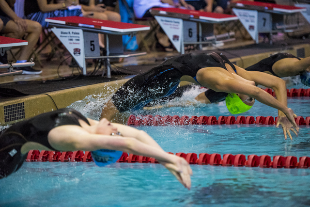 Abby Richter, green cap, of Green Valley comes off the block at the start of the girls 100 y ...