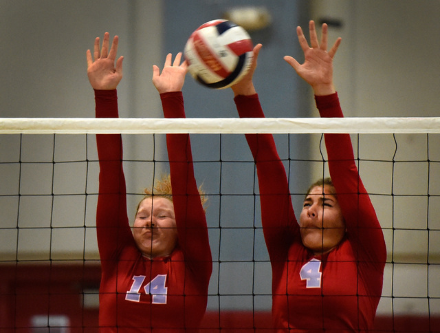 Western’s Camille Riggs (14) and Elaina Tillmond block the ball against Pahrump Valley ...