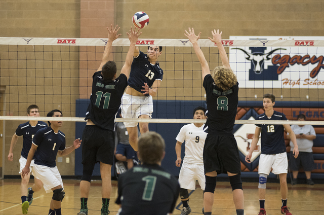 Shadow Ridge’s Cody Heathcock (13) spikes the ball against Palo Verde’s Michael ...